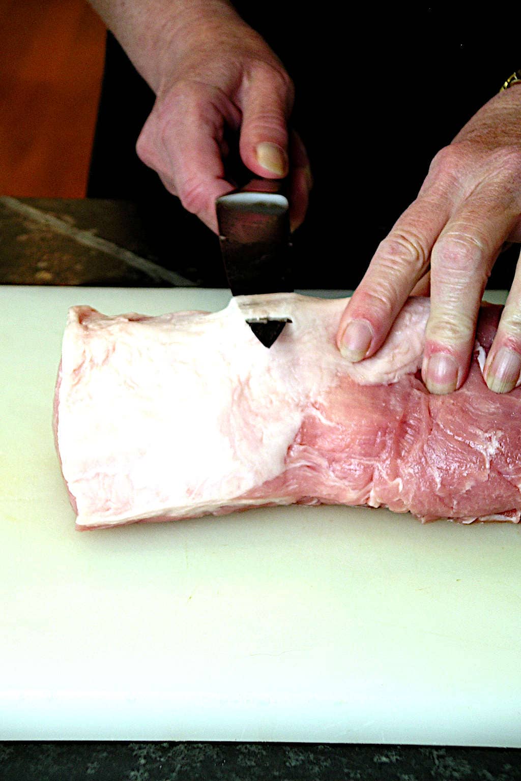 Trimming silverskin from the pork