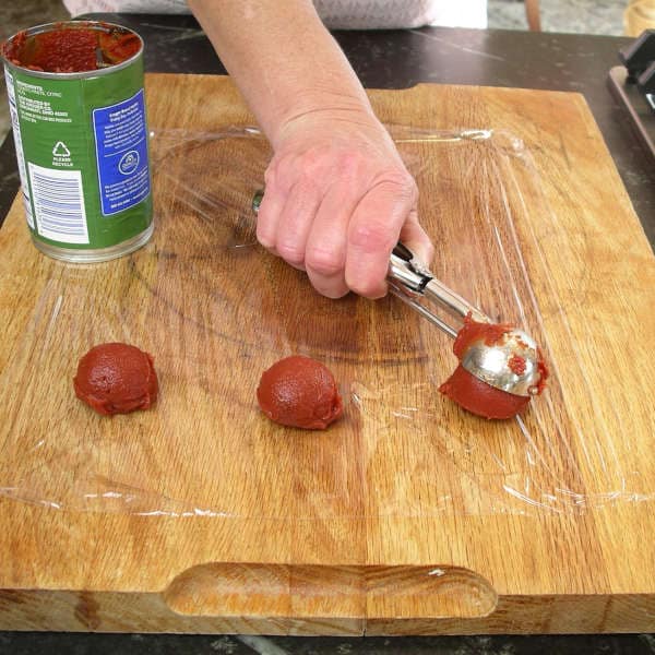 Portioning out tomato paste